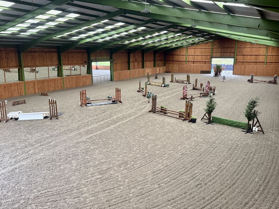 Indoor arena with jumps