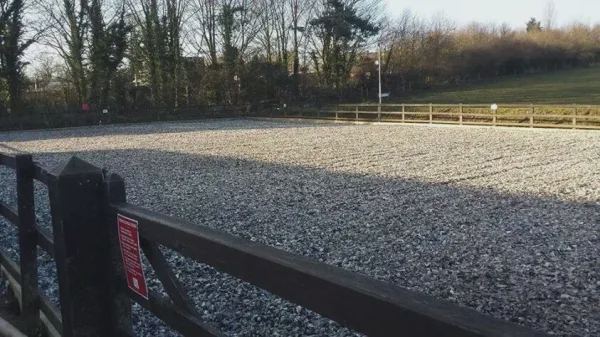 Gravel arena by fence