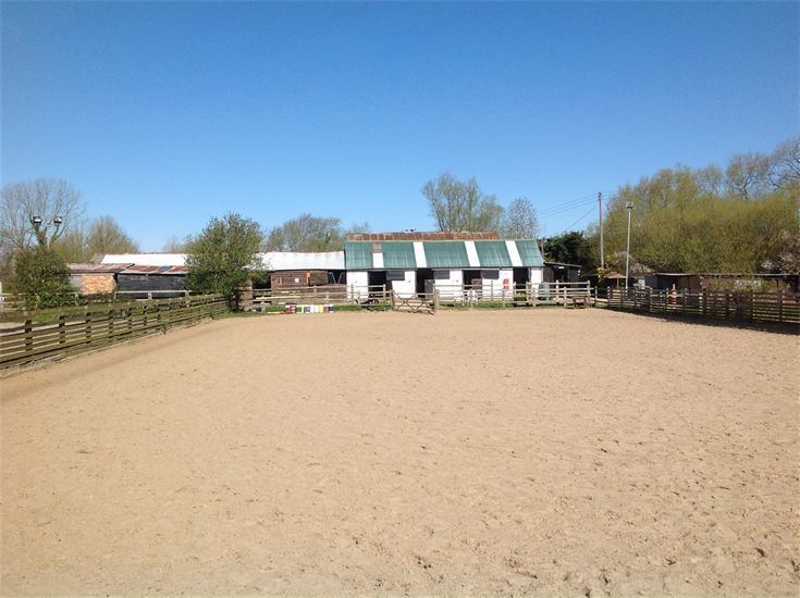 Outdoor arena by stables