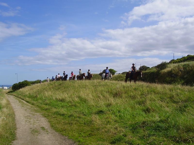 Riders on clifftop path