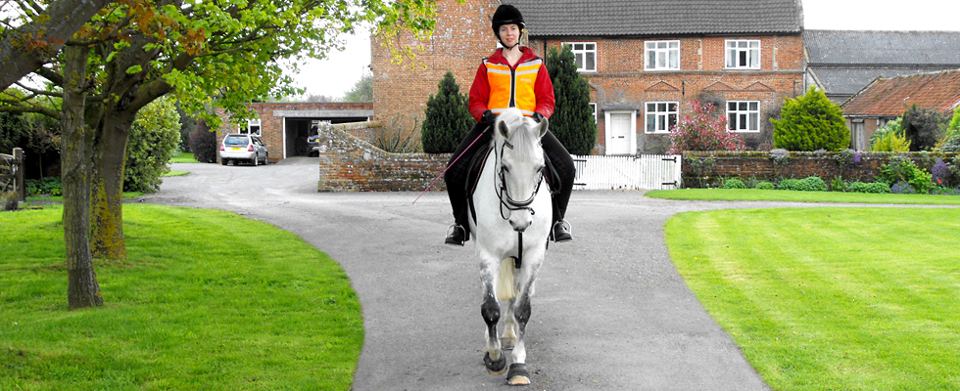 Rider by farmhouse